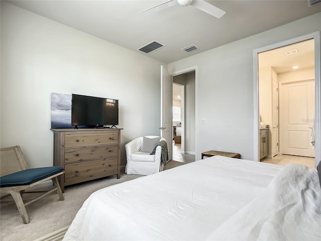 bedroom with light carpet, connected bathroom, visible vents, and a ceiling fan