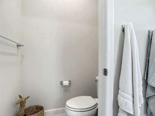 bathroom with toilet and baseboards