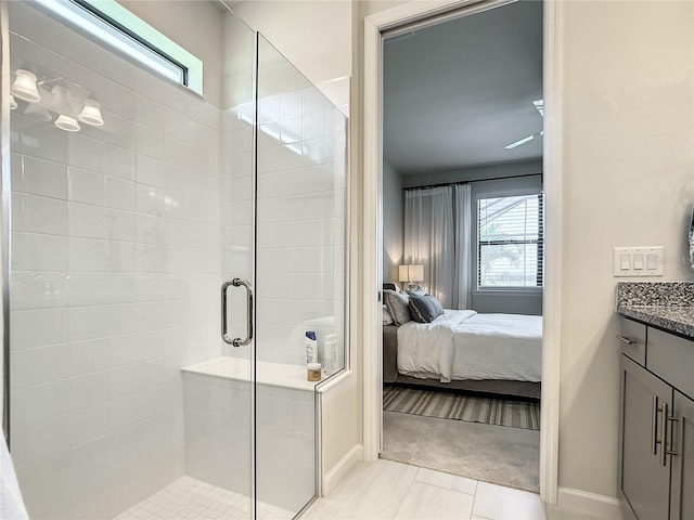 bathroom with baseboards, a shower stall, ensuite bath, and vanity