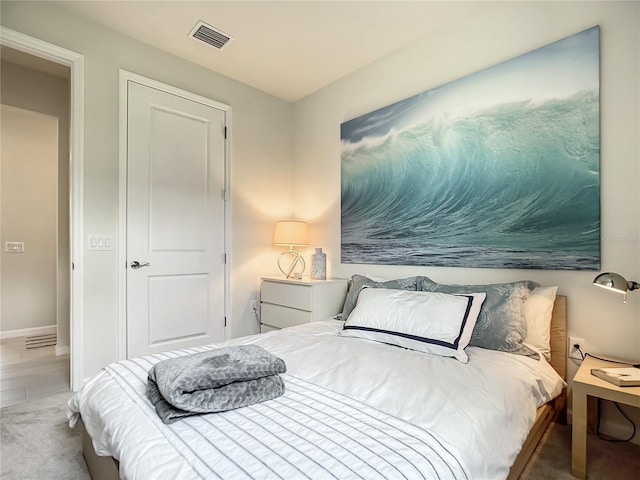 bedroom with visible vents and baseboards