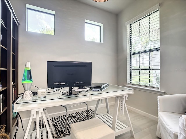 office space featuring a wealth of natural light and baseboards