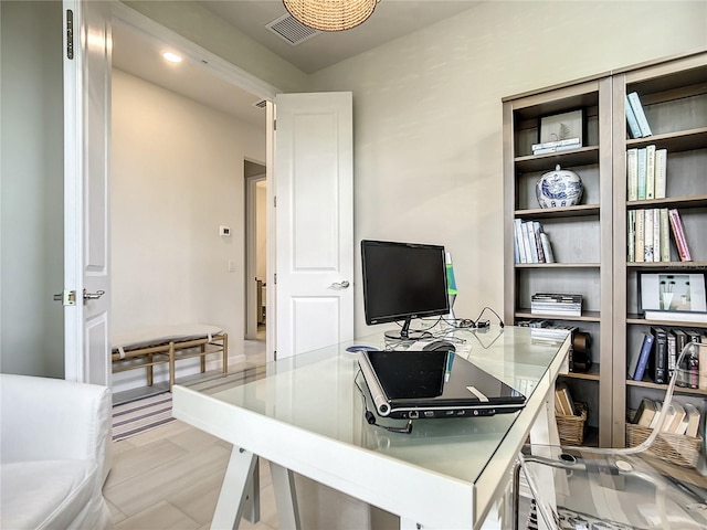 office space with light wood-style floors and visible vents