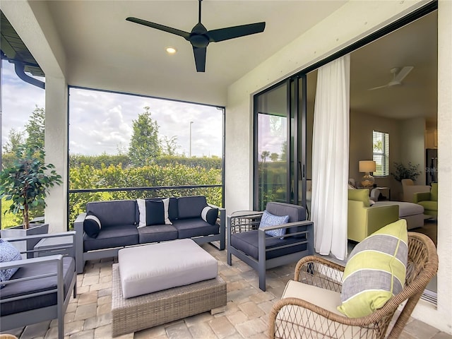 sunroom featuring a ceiling fan