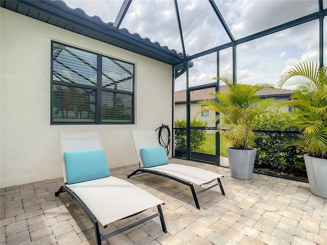 view of patio with glass enclosure