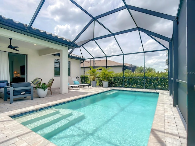 outdoor pool with ceiling fan, a patio, and a lanai