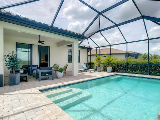 pool with glass enclosure, a patio area, an outdoor living space, and a ceiling fan