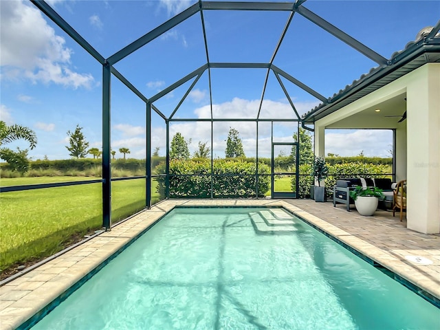 outdoor pool featuring a lanai, a ceiling fan, and a patio