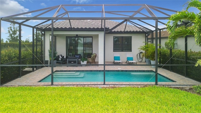 back of house with a lanai, a tile roof, a patio, and stucco siding