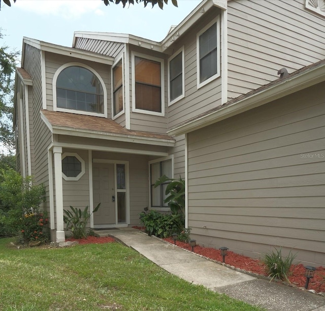 doorway to property with a yard