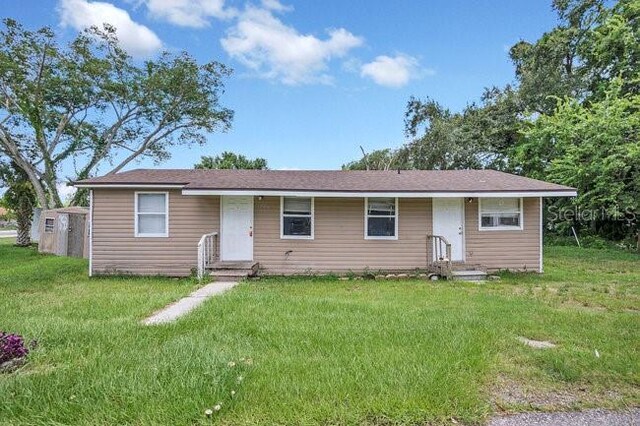 ranch-style home with a front lawn