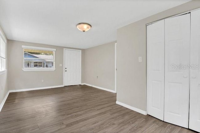 unfurnished bedroom with hardwood / wood-style flooring