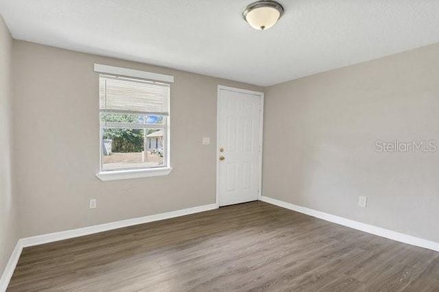 spare room with hardwood / wood-style flooring