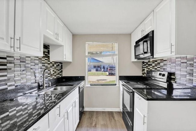 kitchen featuring light hardwood / wood-style flooring, black appliances, white cabinets, sink, and backsplash