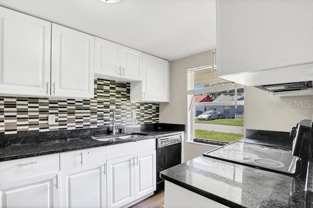 kitchen featuring dark stone countertops, backsplash, black appliances, and sink