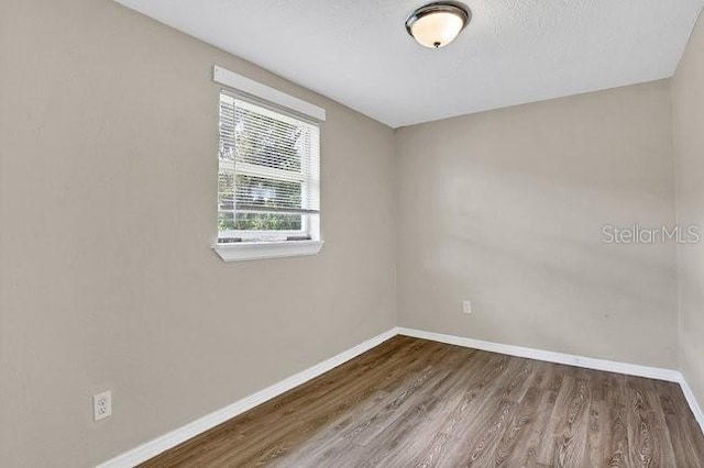 spare room featuring hardwood / wood-style floors