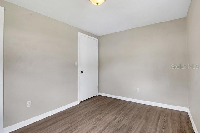 unfurnished room with hardwood / wood-style floors