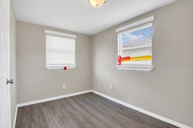 spare room featuring dark hardwood / wood-style floors