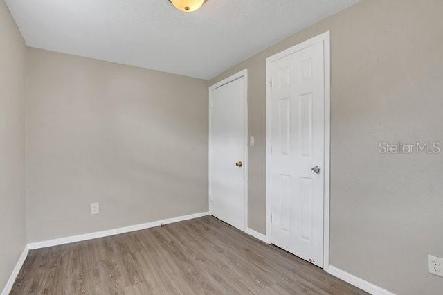 unfurnished bedroom featuring wood-type flooring