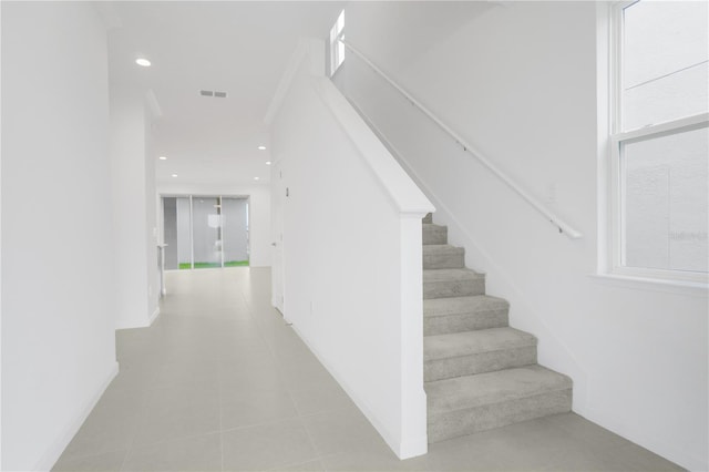 stairs with tile patterned floors