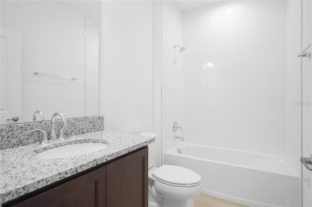 full bathroom featuring washtub / shower combination, toilet, and vanity