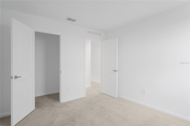 unfurnished bedroom featuring light colored carpet