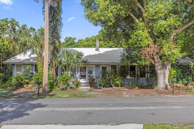 view of front of home with metal roof and a porch