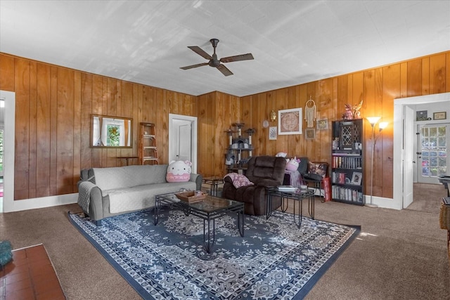 carpeted living area featuring baseboards, a ceiling fan, and a healthy amount of sunlight