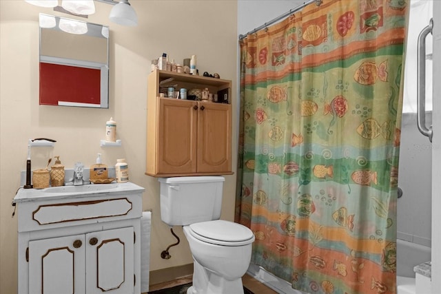 bathroom with toilet, shower / tub combo with curtain, and vanity