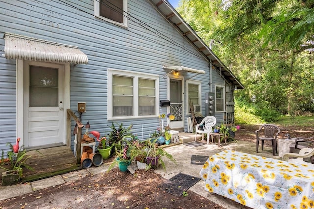 rear view of property featuring entry steps and a patio