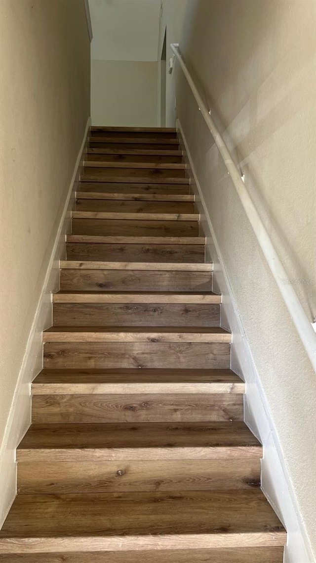 stairs featuring wood-type flooring