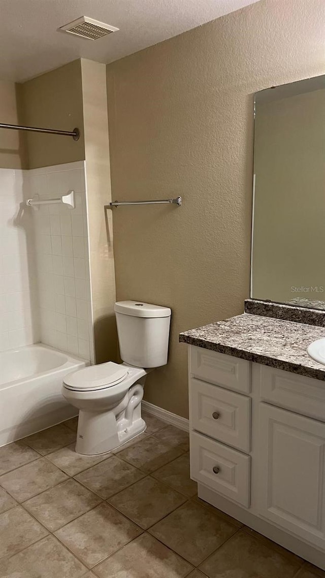 full bathroom featuring tub / shower combination, tile patterned floors, a textured ceiling, toilet, and vanity