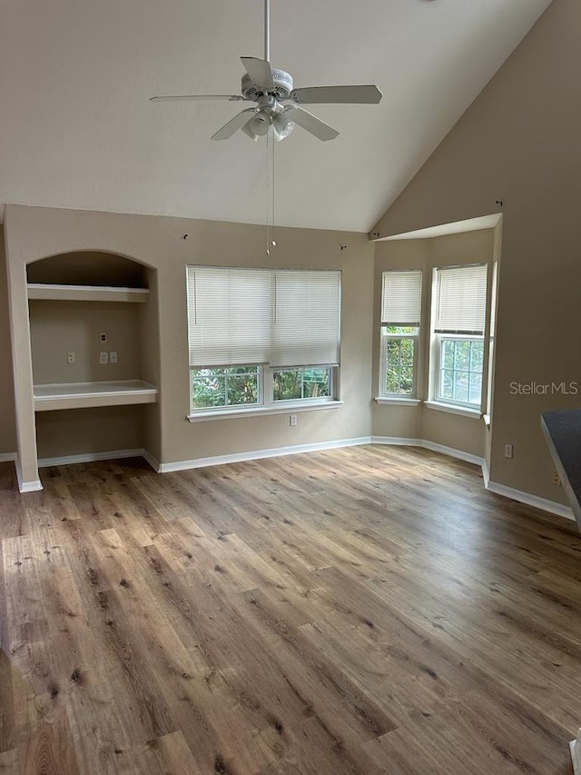 unfurnished living room with ceiling fan, light hardwood / wood-style flooring, and high vaulted ceiling