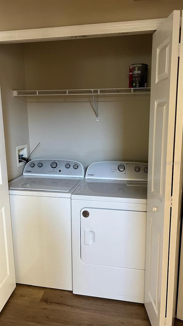 washroom featuring washer and clothes dryer and dark wood-type flooring