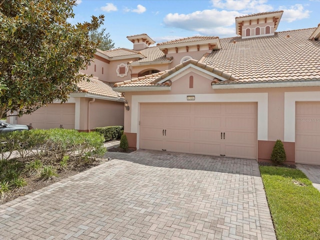 mediterranean / spanish-style home featuring a garage