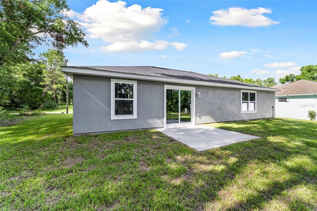 back of house featuring a yard and a patio area