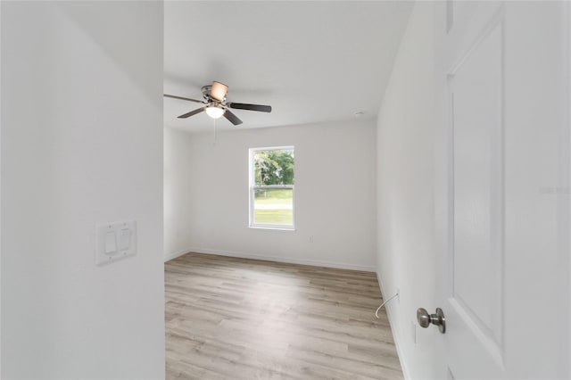 spare room featuring light hardwood / wood-style floors and ceiling fan