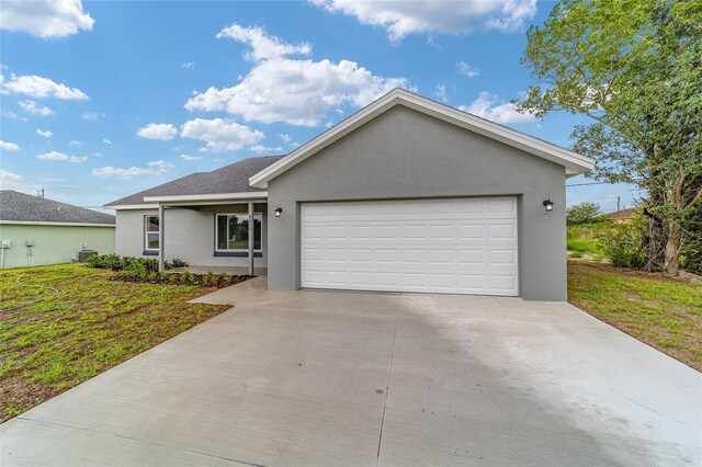 ranch-style house with a garage and a front lawn