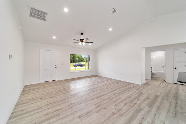 spare room featuring high vaulted ceiling, ceiling fan, and light wood-type flooring