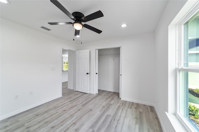 unfurnished bedroom with a closet, ceiling fan, and light wood-type flooring