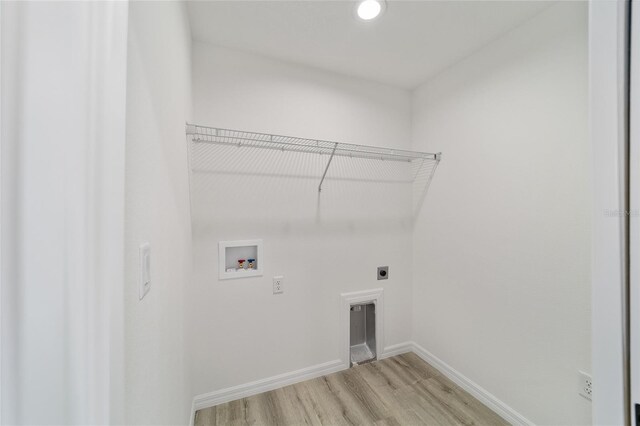 washroom featuring hookup for an electric dryer, light hardwood / wood-style flooring, and washer hookup