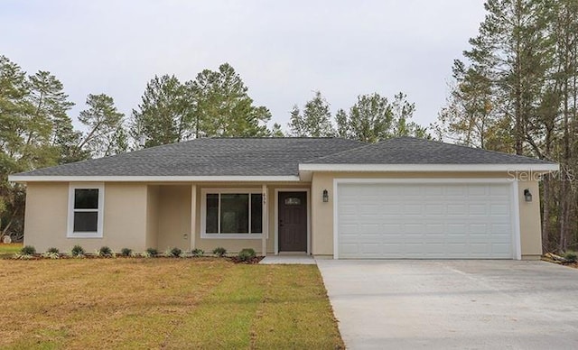 ranch-style house featuring a garage and a front lawn