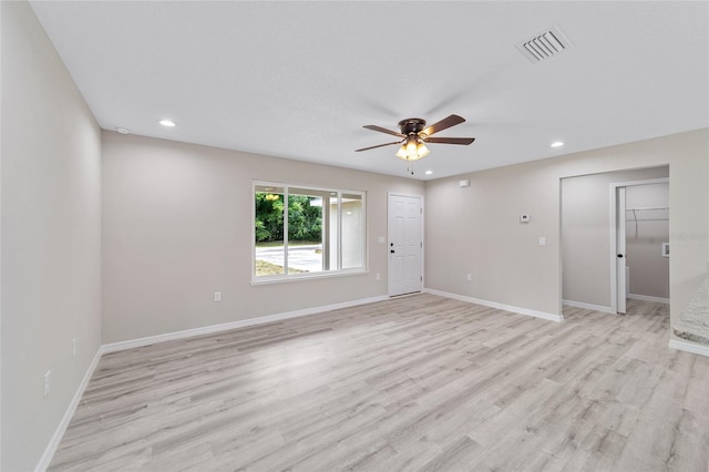 empty room with light hardwood / wood-style flooring and ceiling fan