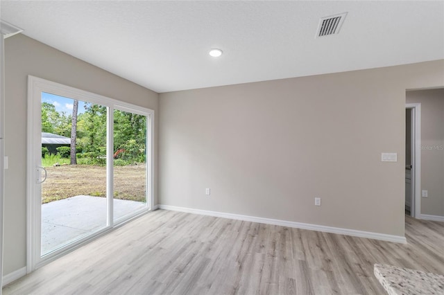 unfurnished room featuring light hardwood / wood-style floors