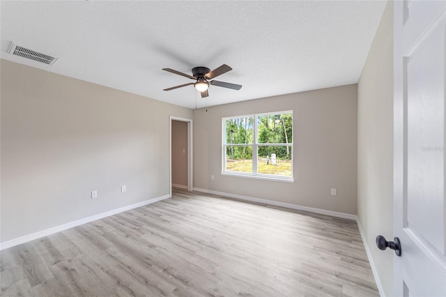 empty room with light hardwood / wood-style flooring and ceiling fan