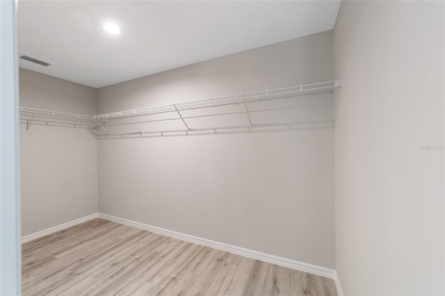 spacious closet with light hardwood / wood-style flooring