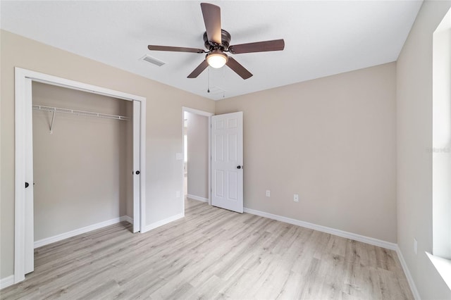 unfurnished bedroom featuring light hardwood / wood-style flooring, a closet, and ceiling fan