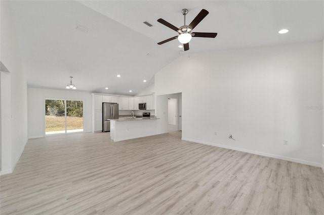 unfurnished living room with ceiling fan, sink, light hardwood / wood-style flooring, and high vaulted ceiling