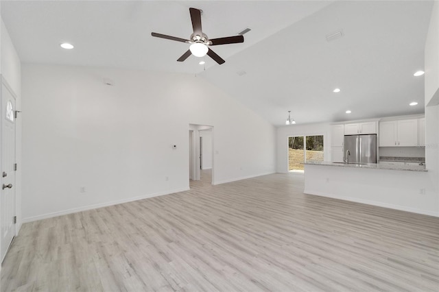 unfurnished living room featuring high vaulted ceiling, sink, light wood-type flooring, and ceiling fan