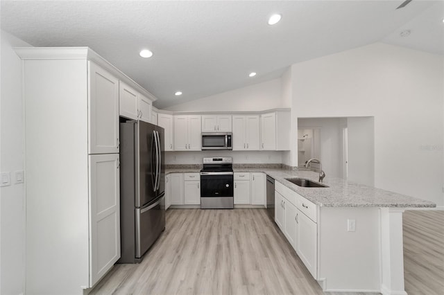 kitchen featuring appliances with stainless steel finishes, light hardwood / wood-style flooring, sink, kitchen peninsula, and light stone countertops