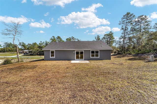 rear view of property with a patio and a lawn